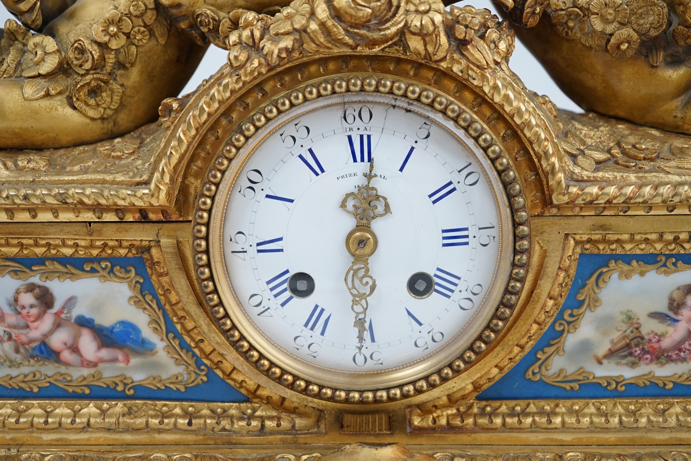 A 19th century French ormolu and Sevres style porcelain mantel clock